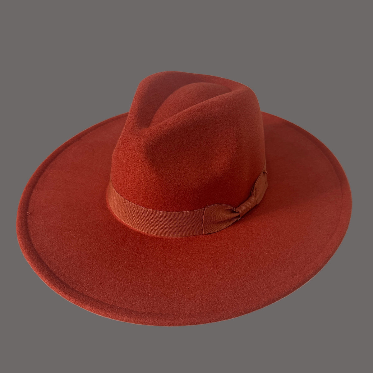 Dion rust wide-brim fedora with a matching grosgrain bow band.