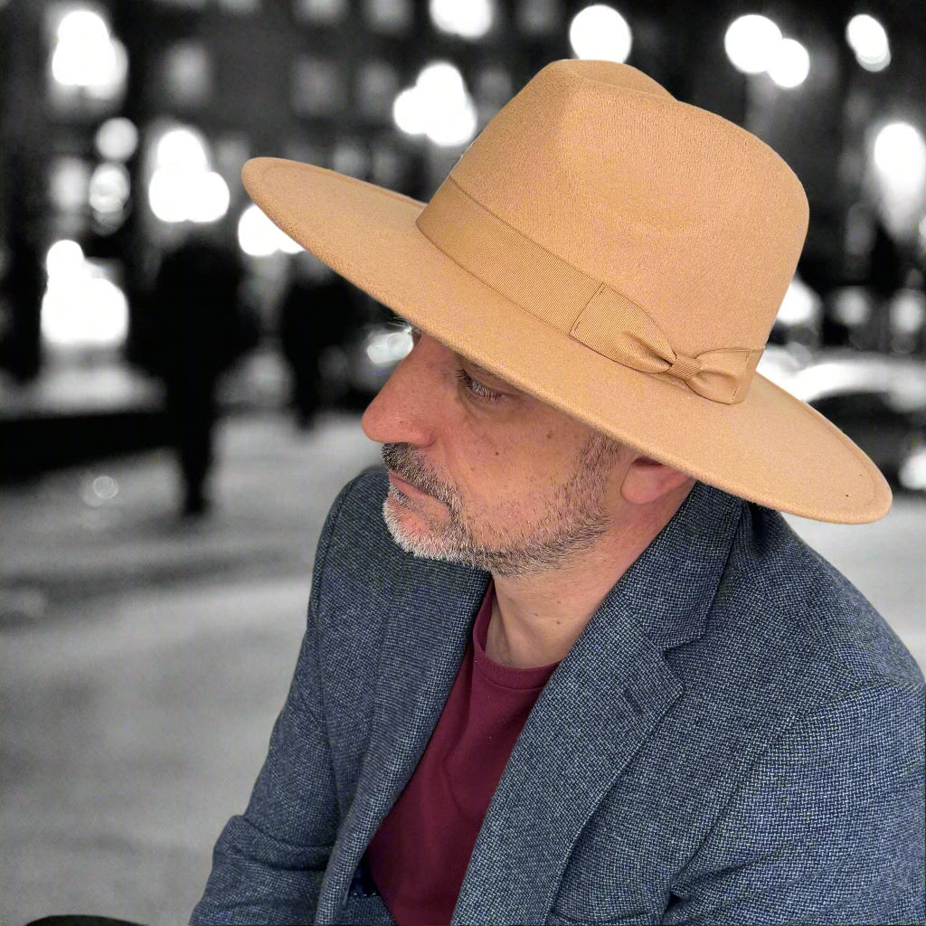 Man wearing a beige Dion wide-brim fedora outdoors.