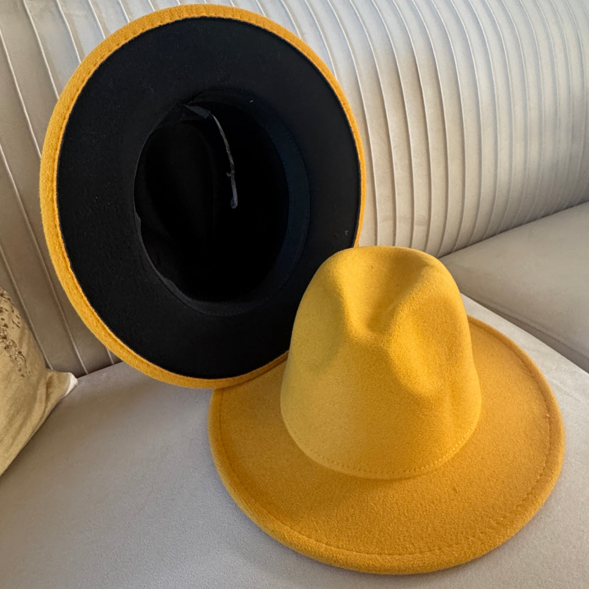 Zair yellow fedora displayed upright and inverted to show a black brim underside.