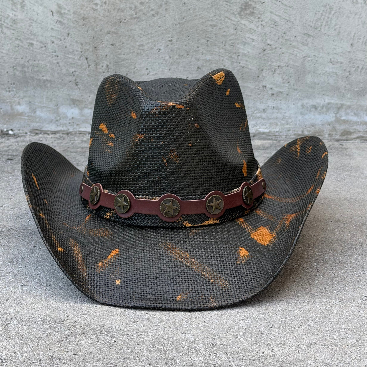 Front view of the Coyote black and tan cowboy hat on a gray background
