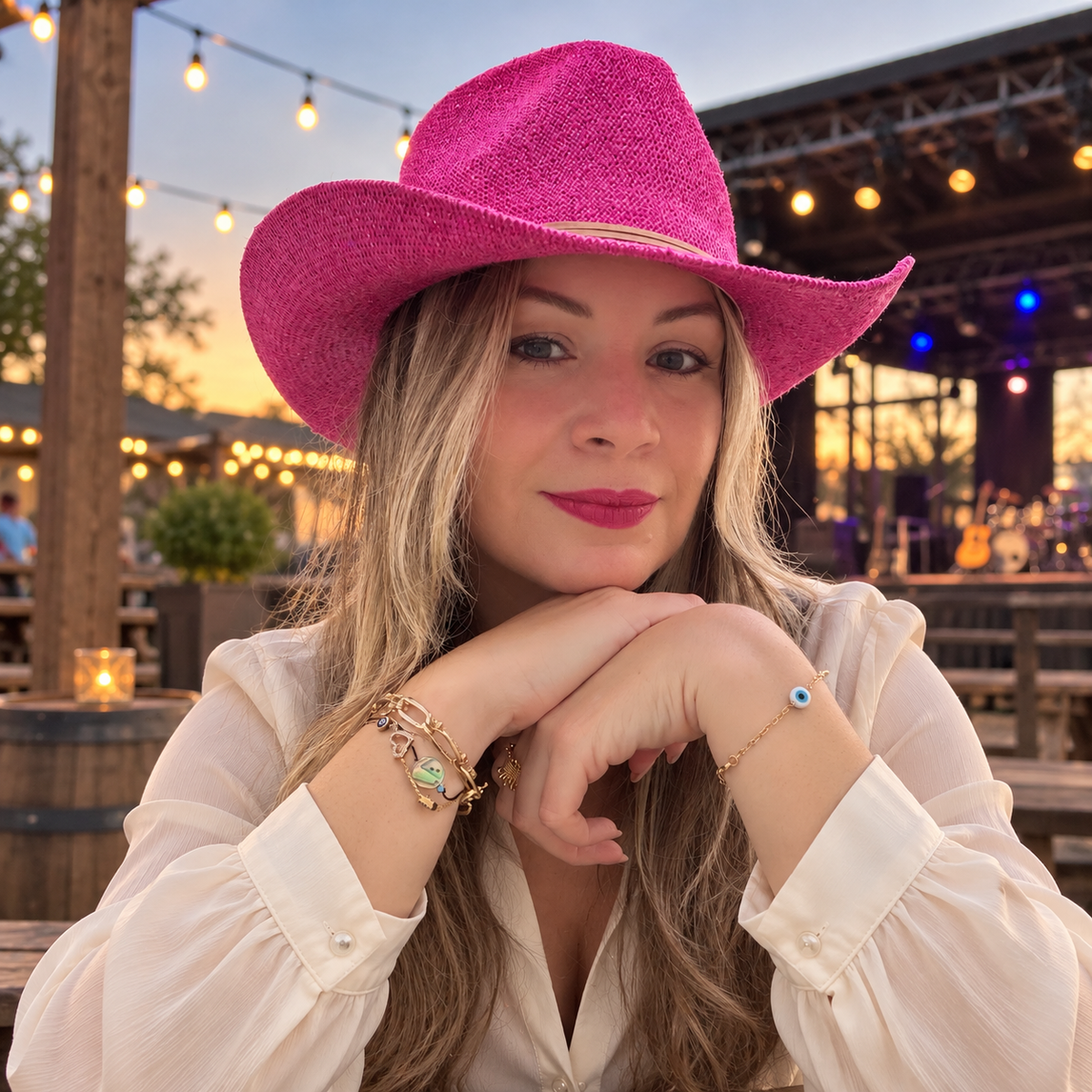 Woman wearing Stella Pink sequin cowboy hat at an outdoor music venue
