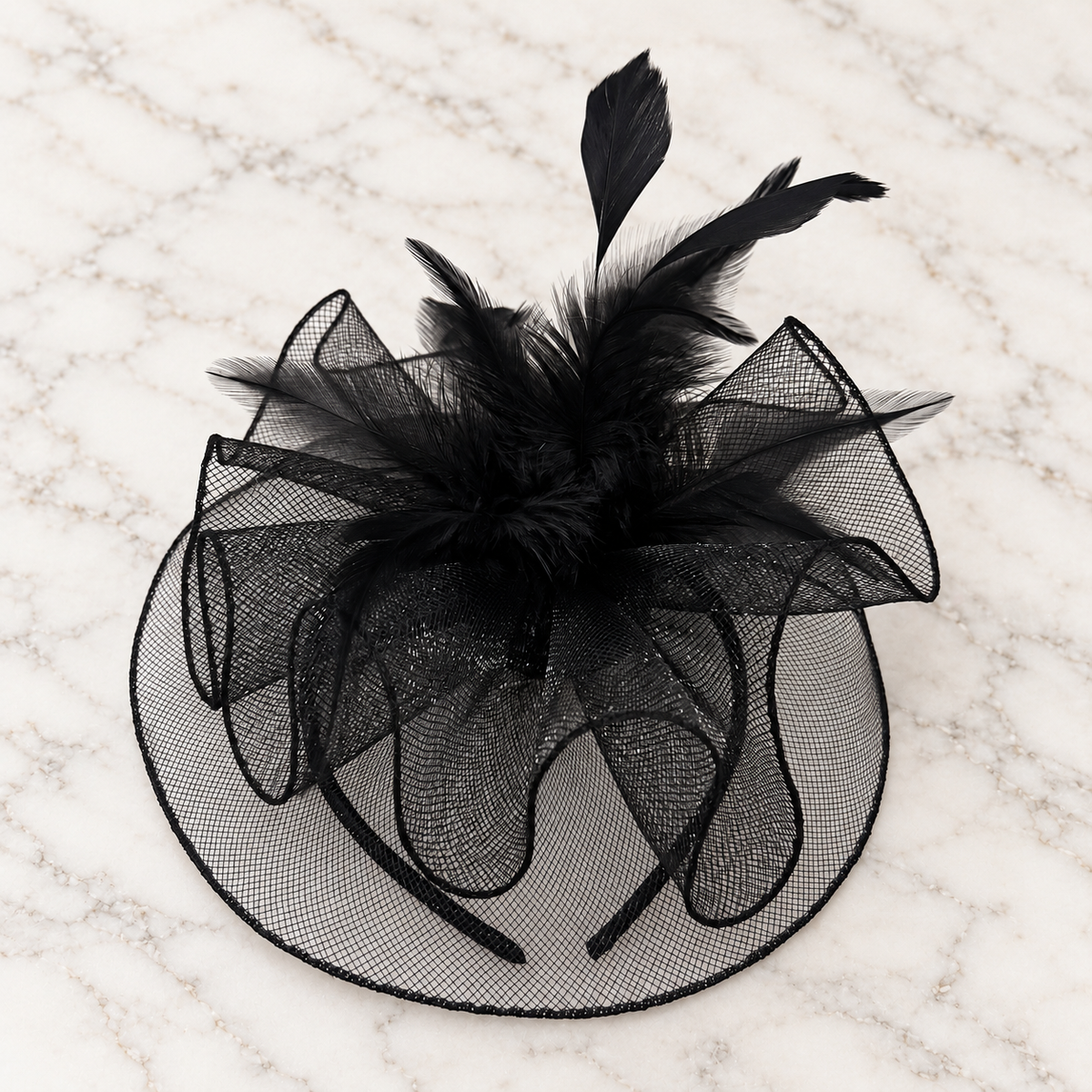 Anastacia black mesh and feather fascinator on light marble background