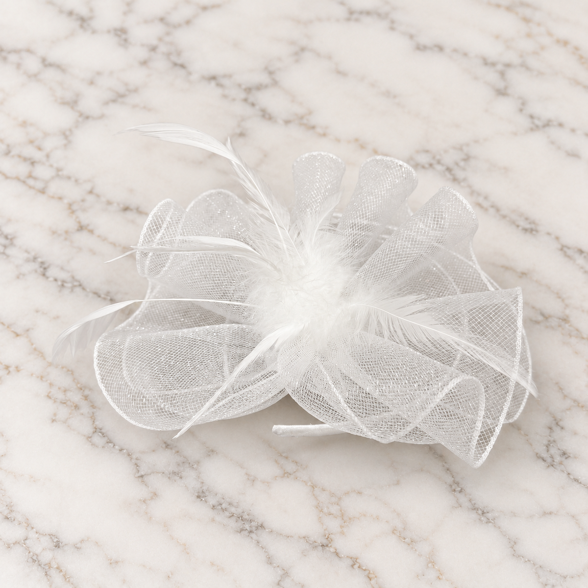 White Anastacia mesh and feather fascinator on light marble background