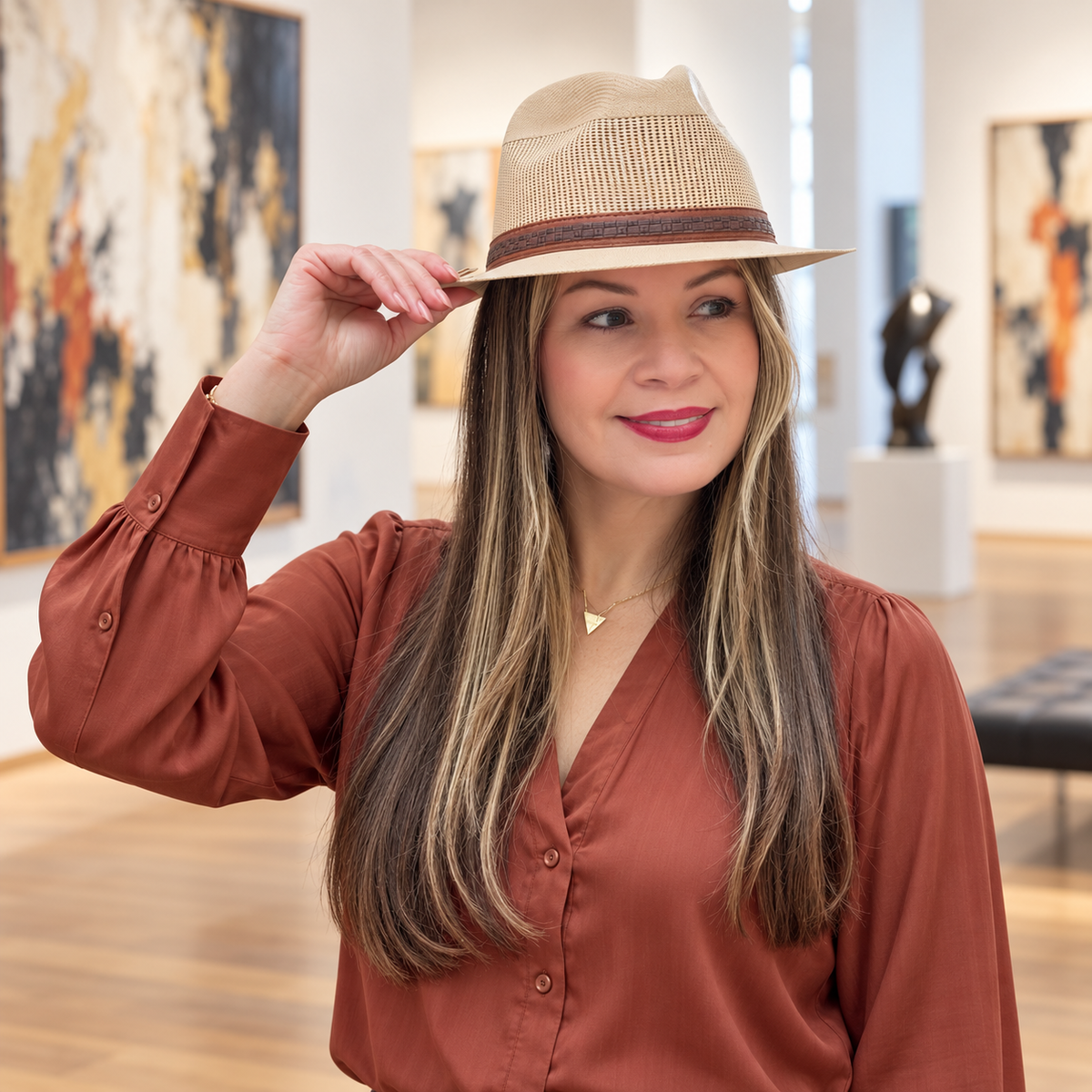Woman wearing Arena vented natural fedora in an art gallery