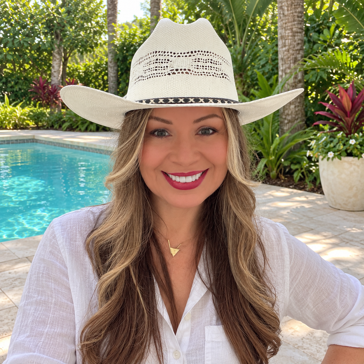 Woman wearing the white Cody open weave cowboy hat beside a pool