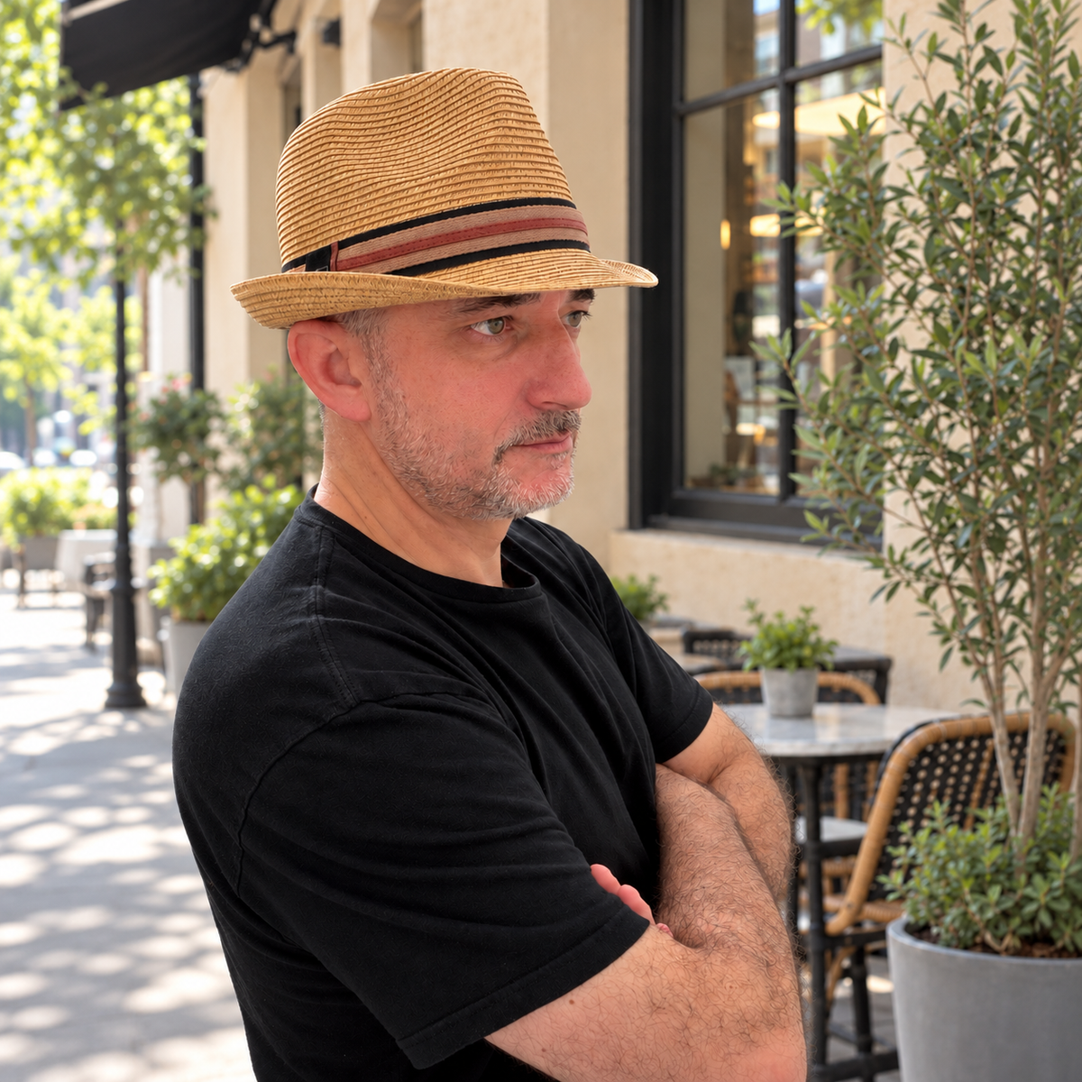 Man wearing Fer tan striped-band fedora at an urban cafe.