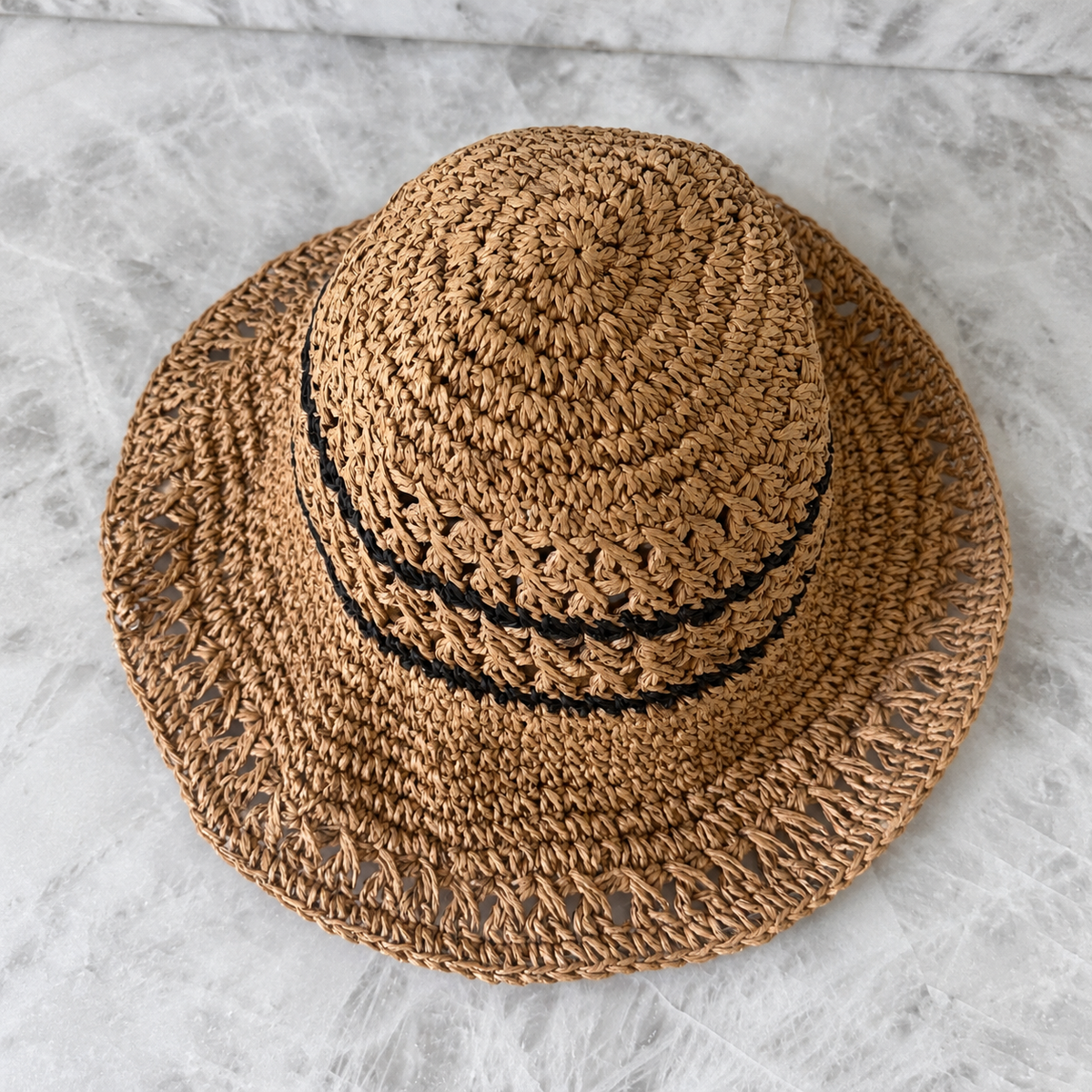 Overhead view of Karina tan crochet bucket hat showing the crown and open weave
