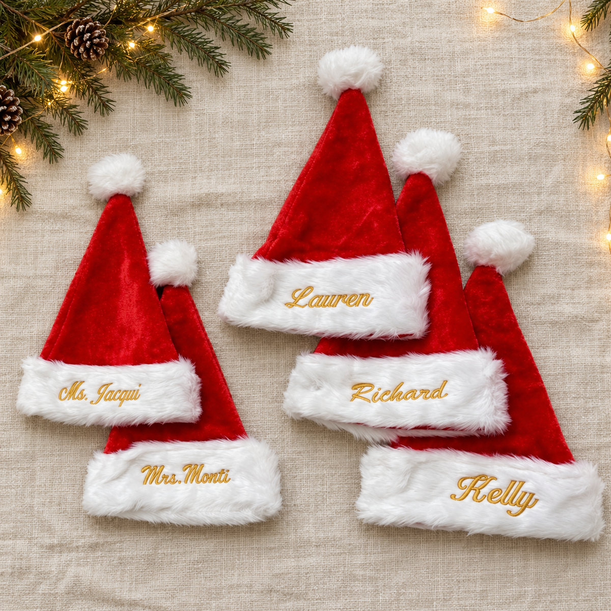 Five Santa hats with gold names on a Christmas background