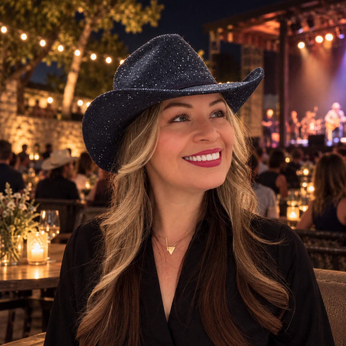 Woman wearing Stella Blue navy sequin cowboy hat at an outdoor evening concert