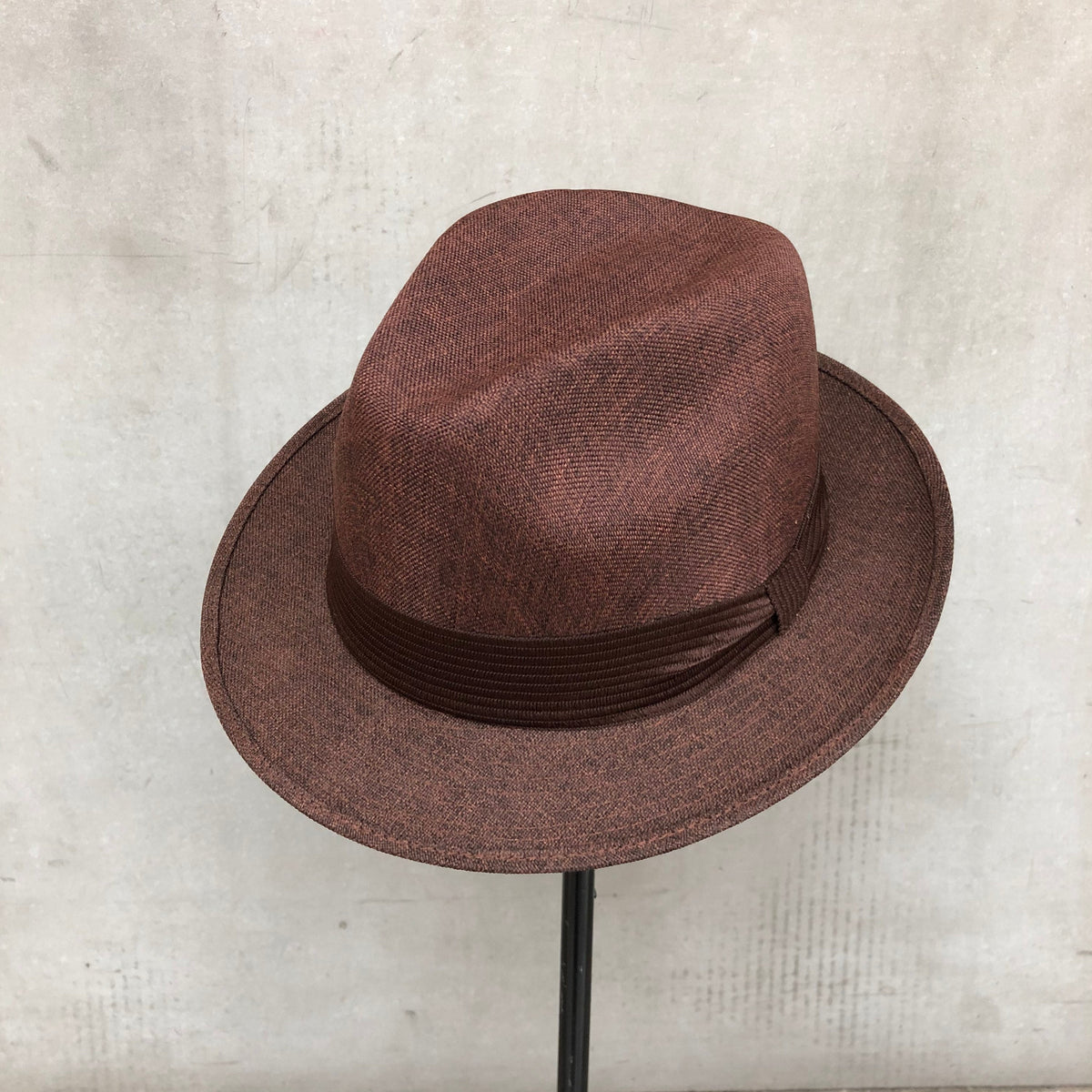 Mia brown structured fedora with a matching pleated band and short brim.
