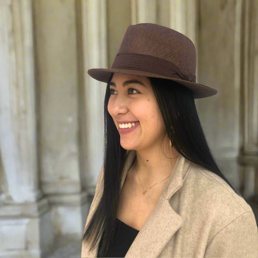 Woman wearing Mia brown structured fedora outside a building.