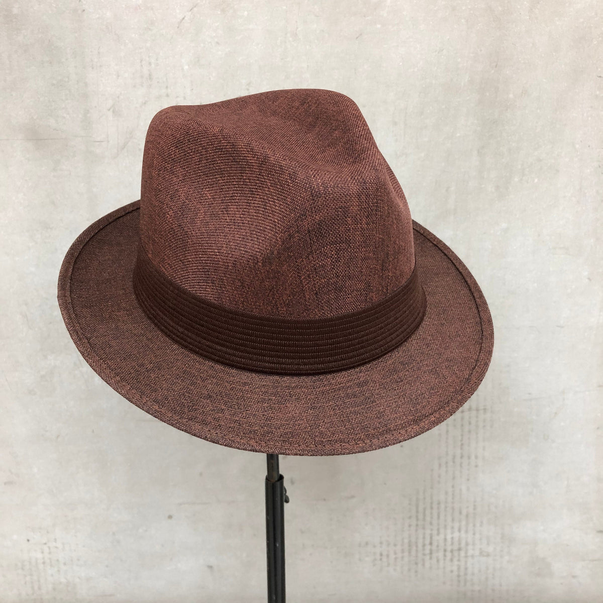 Mia brown structured fedora with a matching pleated band and short brim.