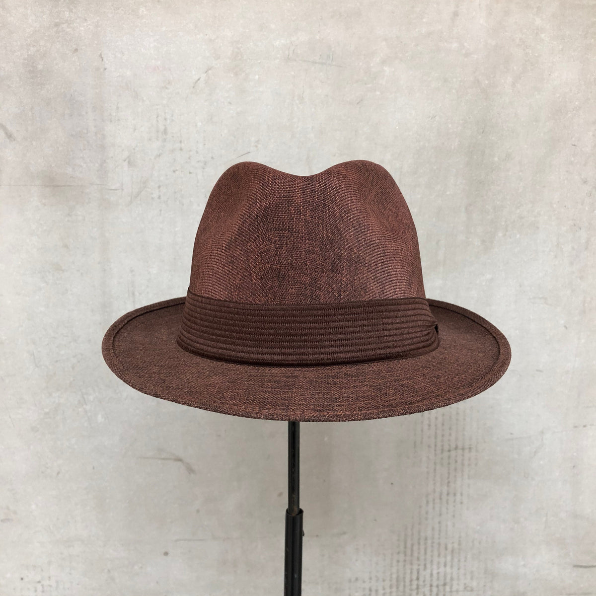 Mia brown structured fedora with a matching pleated band and short brim.