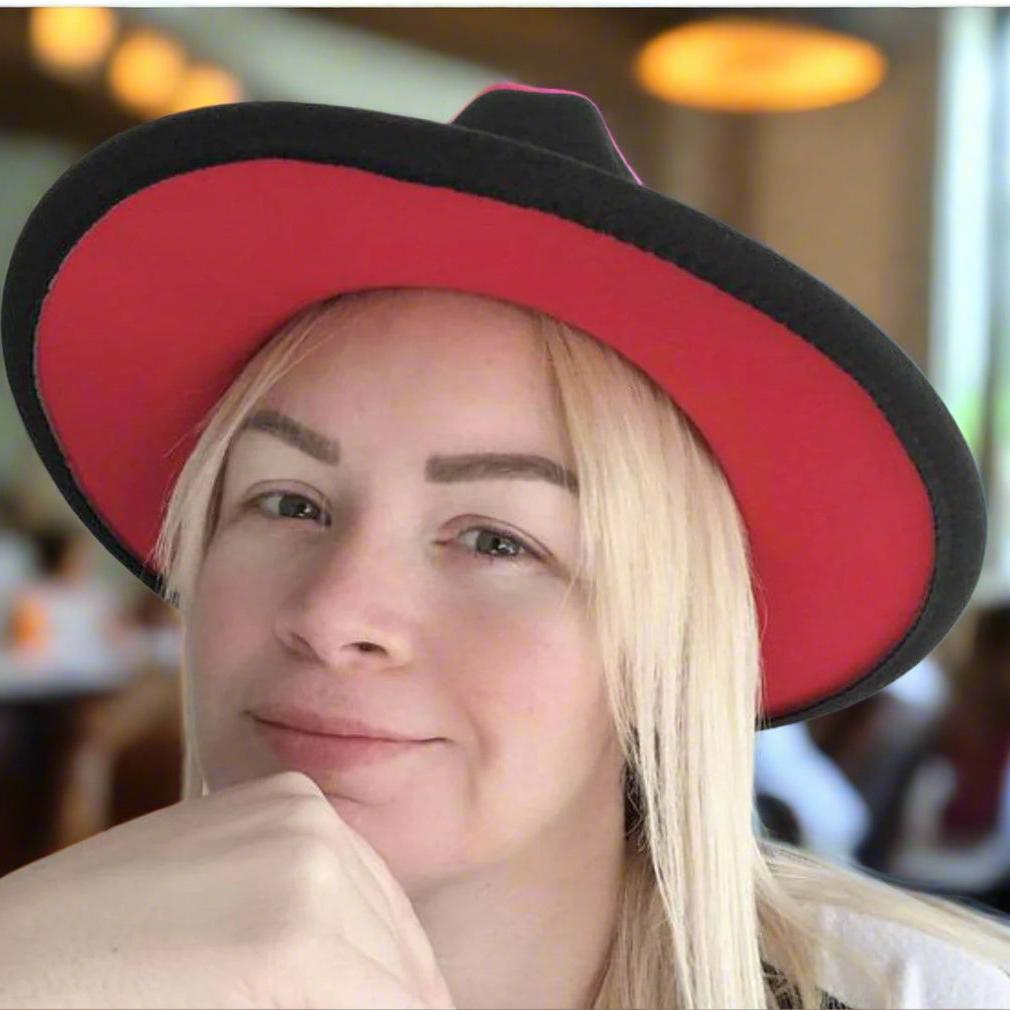 Woman wearing a Zair black fedora showing its red brim underside.