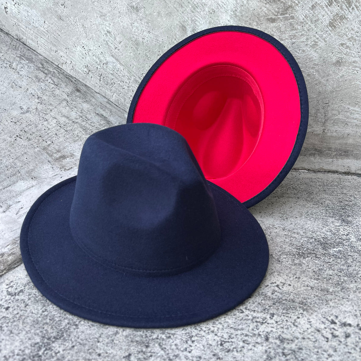 Zair dark two-tone fedora displayed with its bright red brim underside.