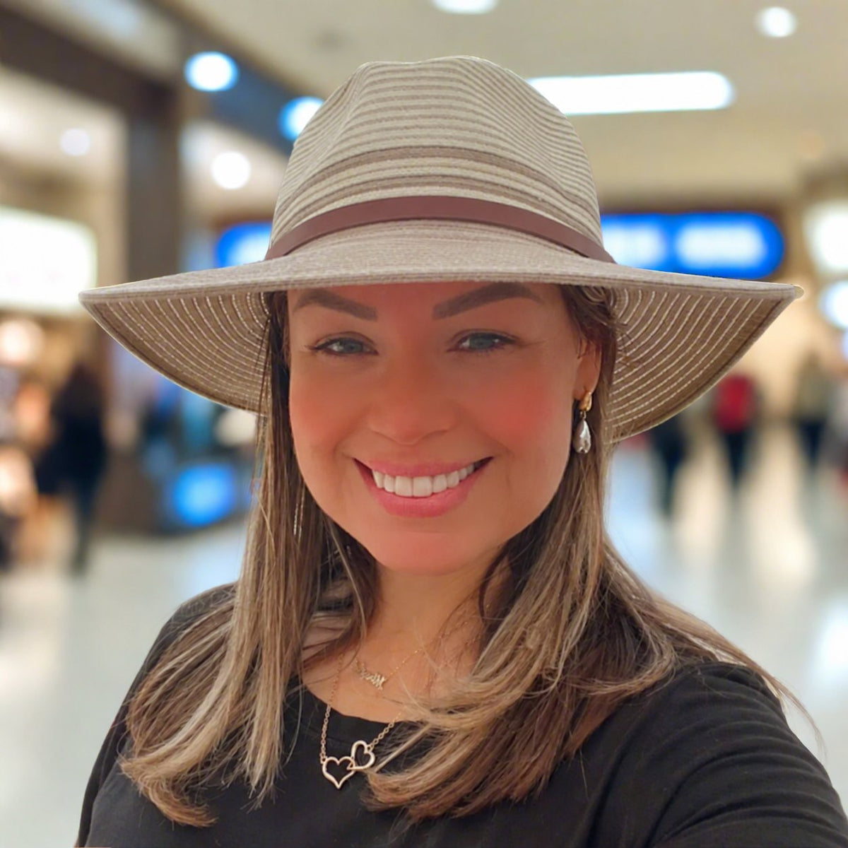 Elan hat worn by a woman indoors.