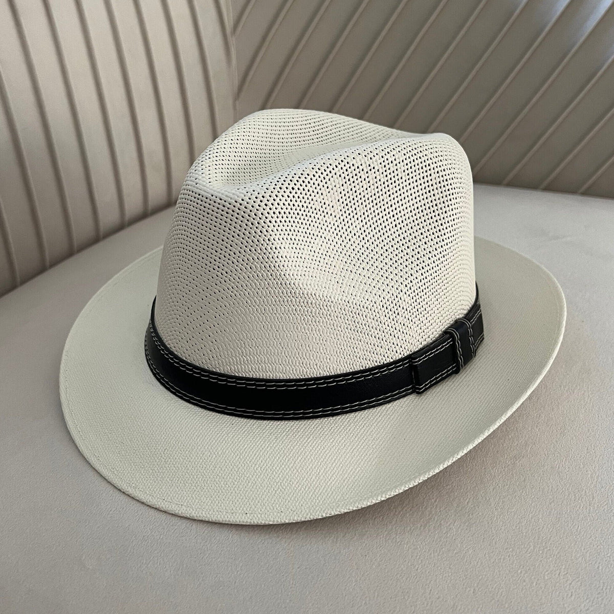 Mara off-white vented fedora with a narrow black stitched band.