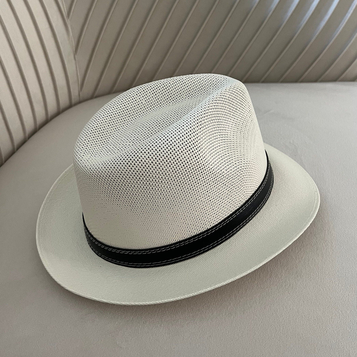 Mara off-white vented fedora with a narrow black stitched band.