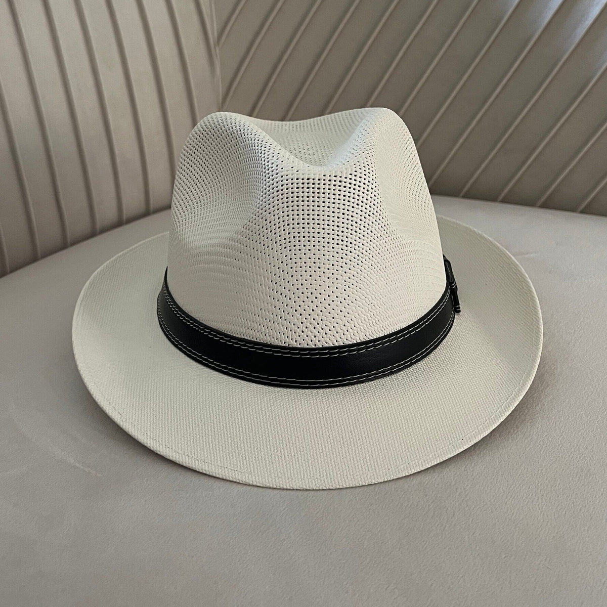 Mara off-white vented fedora with a narrow black stitched band.